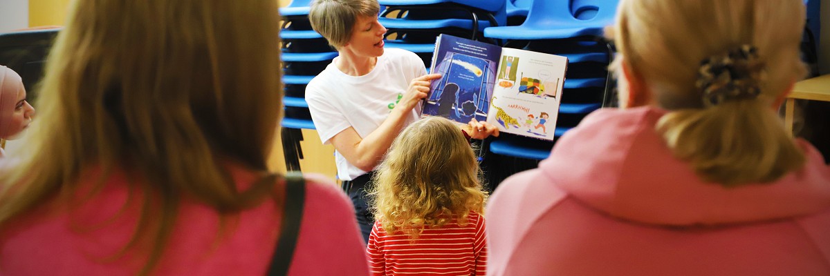 Director Katie Green reads a story to a group of children and their grown-ups, researching ideas for the SEED performance
