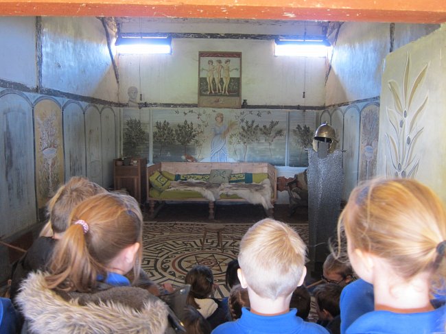 Photo by Katie Green; the children of St Mary's School visiting the Roman Villa at Butser Ancient Farm